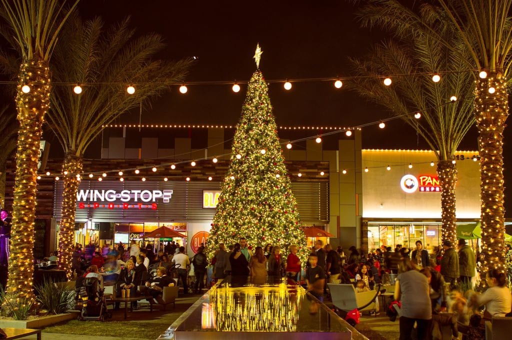 Christmas tree centerpiece in a commercial shopping center with retail stores and restuarants