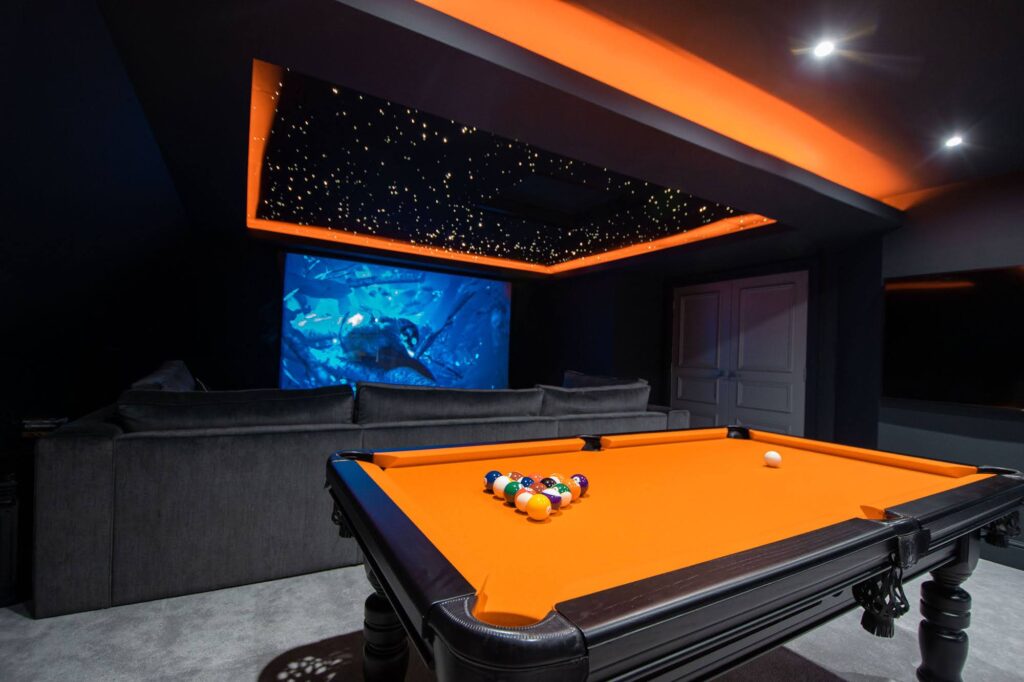 star ceiling with orange bright accent lights match an orange pool table
